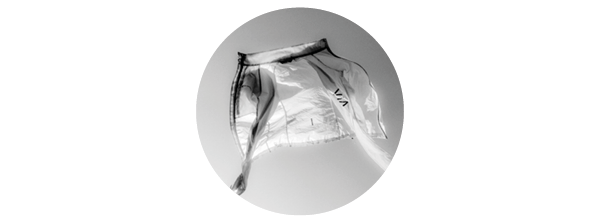 A black and white image of a montane jacket thrown into the air.