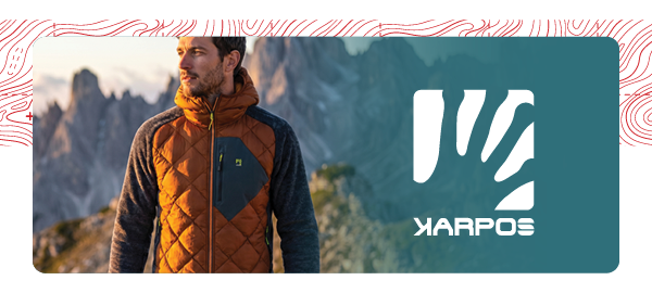 KARPOS. A man wears Karpos Men's Marmarole Up Jacket in Orange/Grey.