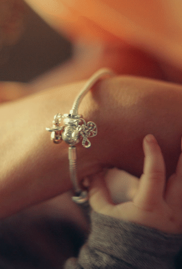Woman with bracelet and newborn