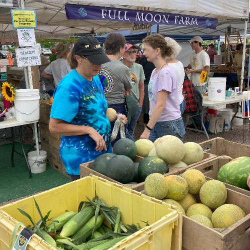Photo: A vendor and shoppers at the Burlington (Vermont) Farmers Market in August 2022. Photo by Alice Christian; used with permission.