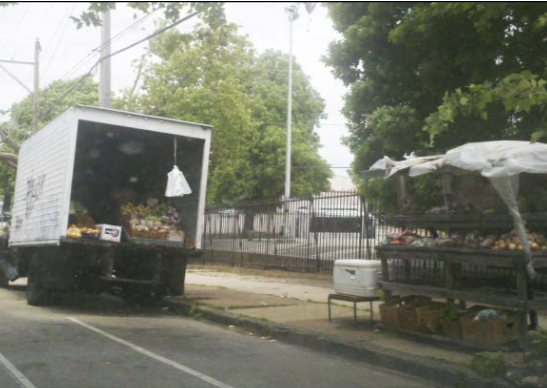 Photo from the article: Note the auxiliary wooden display units outside the box truck.
