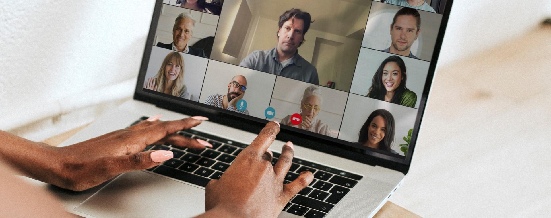 Une dame tape sur un clavier d'ordinateur et un &eacute;cran qui affiche des participants d'une rencontre virtuelle.
