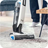 vacuum cleaner in use on rug