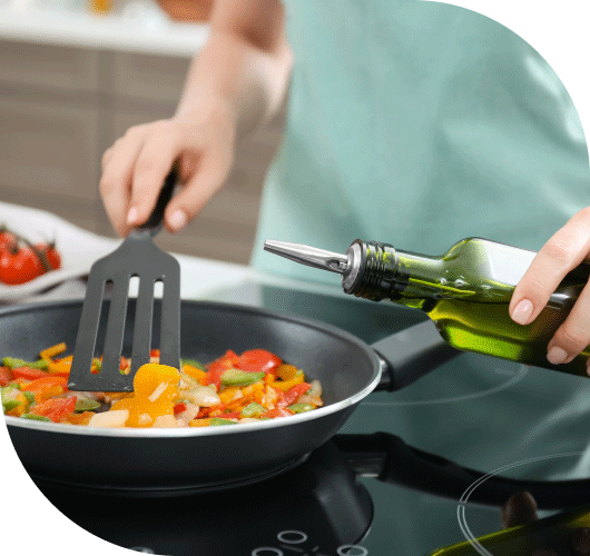 Cooking fresh vegetables with olive oil on a stove, perfect for market-fresh meals