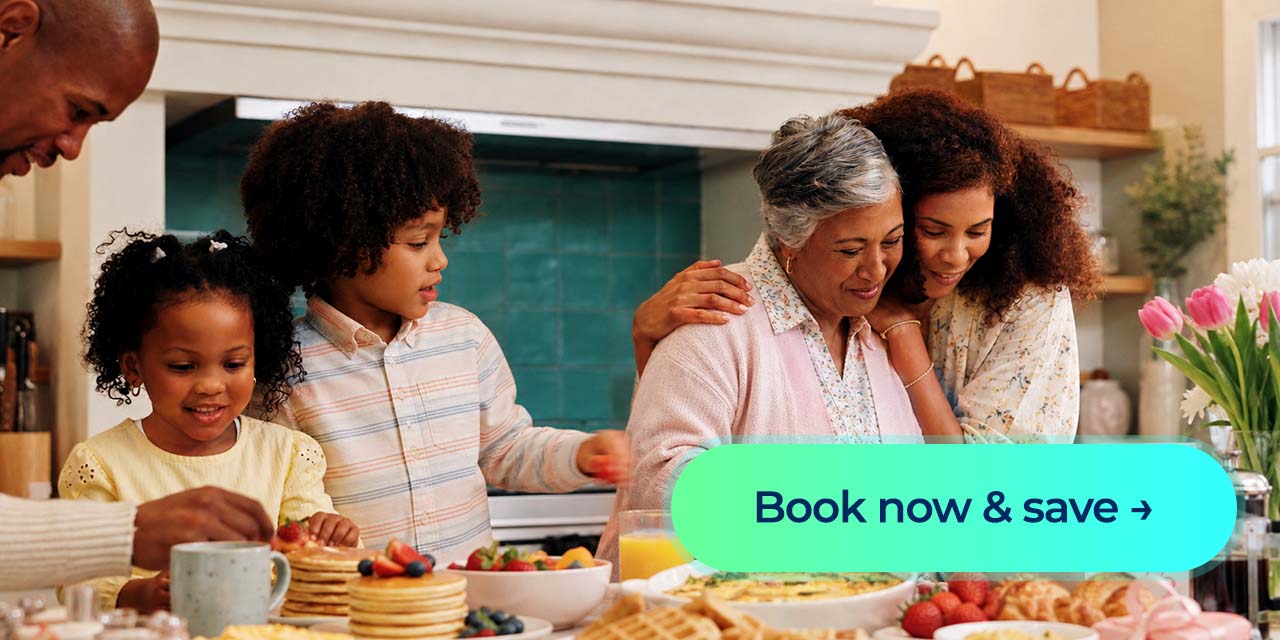 Family gathers around a Mother’s Day brunch table with pancakes, fruit and flowers, alongside a “Book now and save” button.
