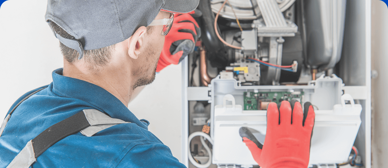A technician works on a furnace unit