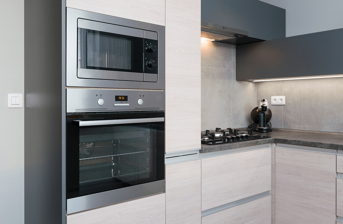 A wall oven alongside modern cabinetry