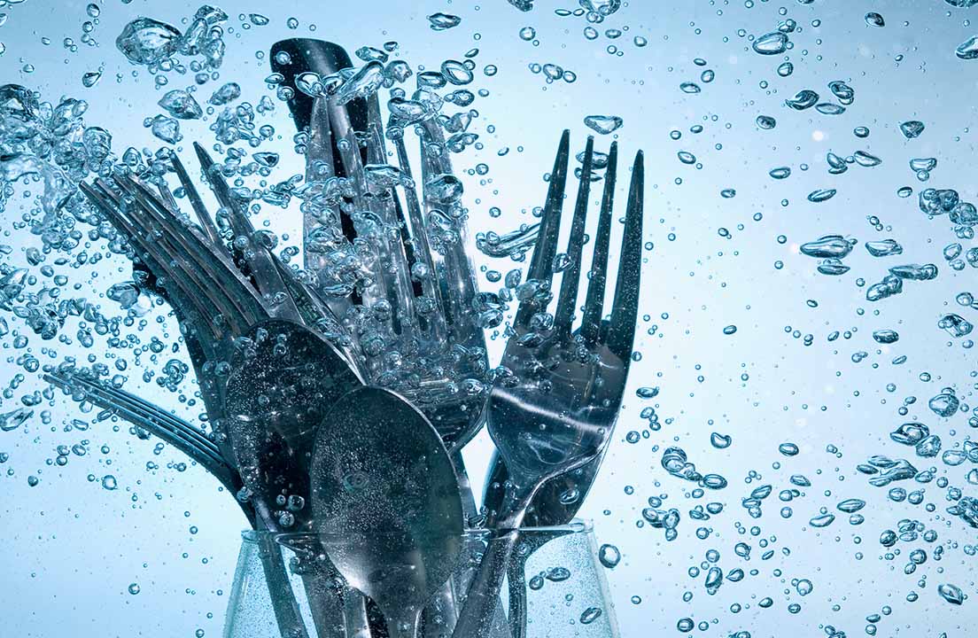 Submerged silverware that are placed inside of a wine glass