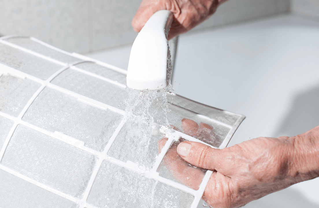 A person washing an HVAC filter