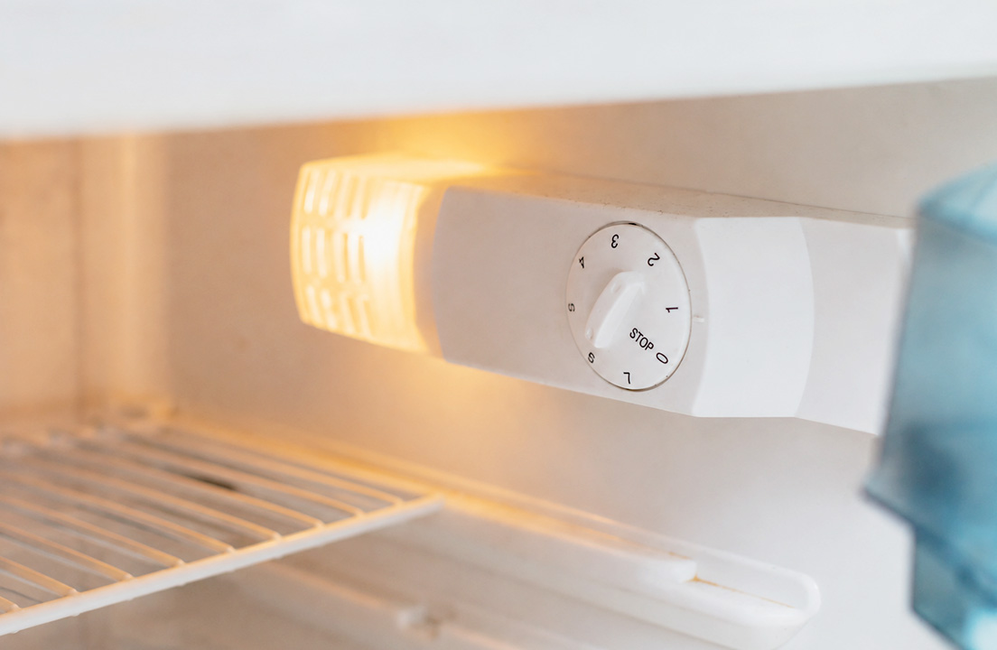 Refrigerator temperature control dial inside an empty fridge