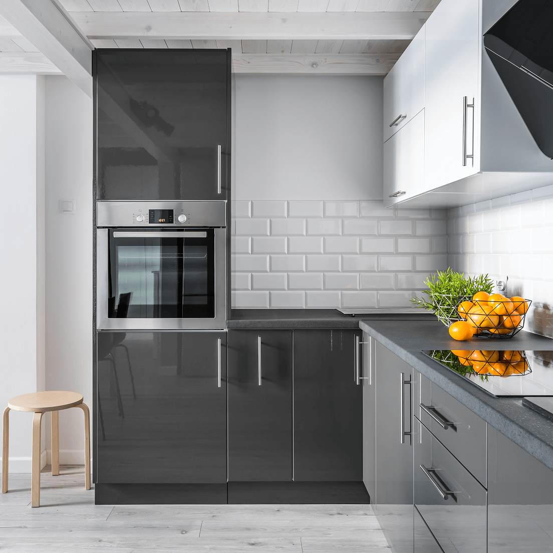 A modern kitchen that shows modern cabinetry and a wall oven