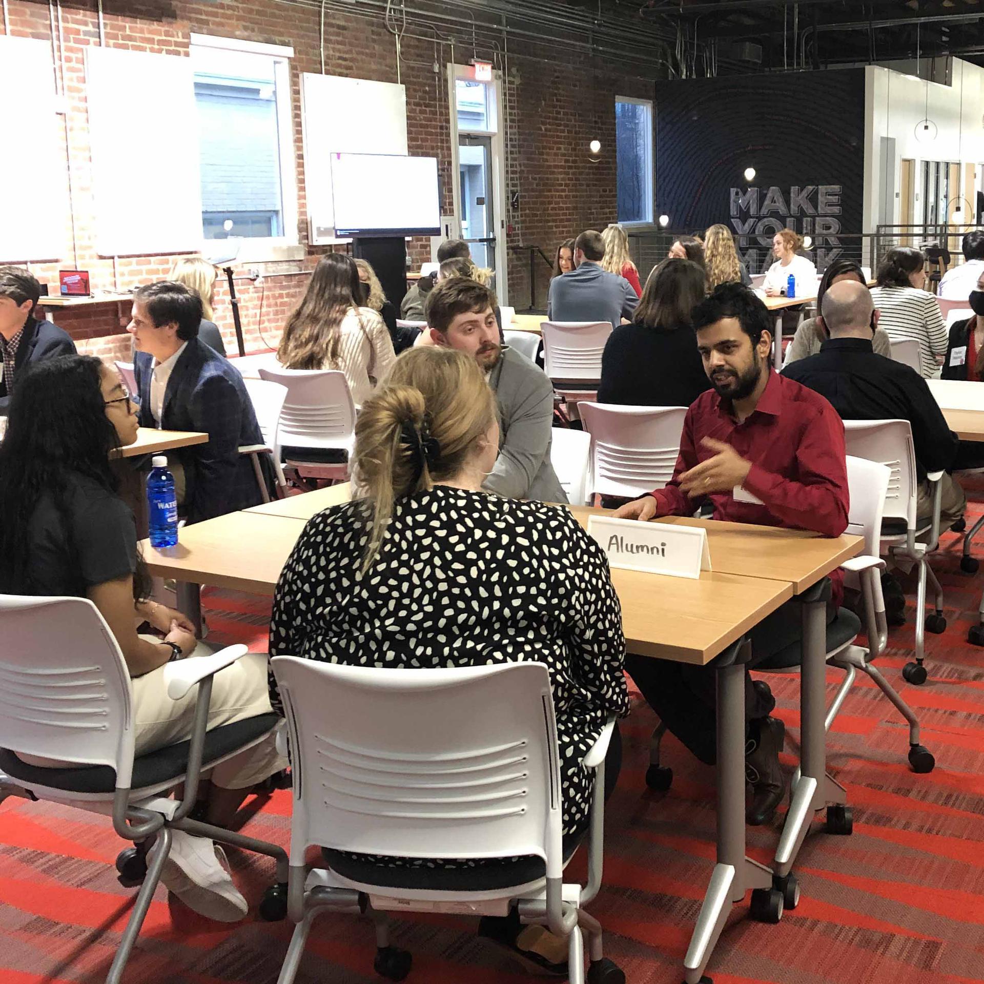 Students talking with alumni at the spring Intros and Appetizers event