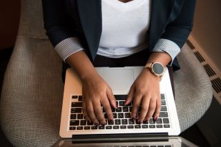 Woman Typing on Laptop