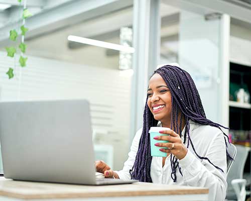 Woman at Laptop with Cup of Coffee