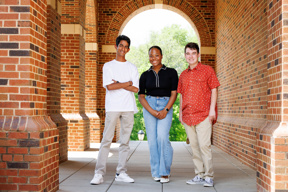 Buhusuru Ranasinghe, Lauryn Sanders and Anthony Tringali stand in an archway at UGA's Business Learning Community