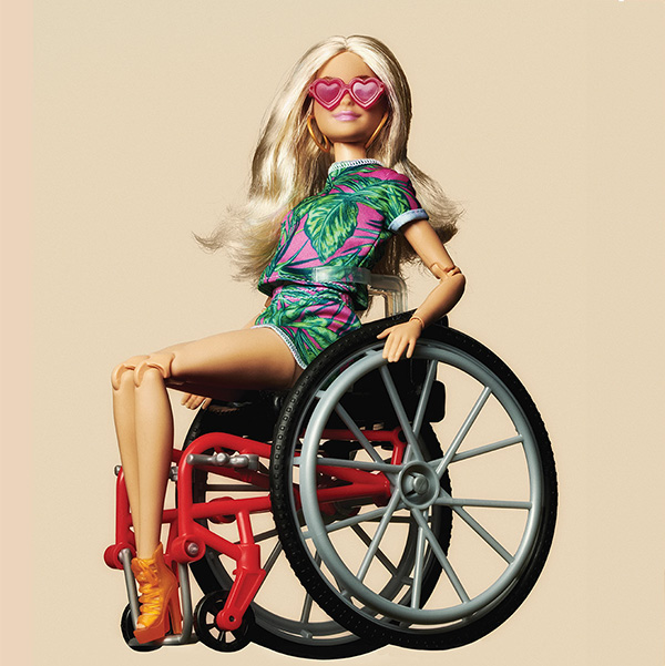 Photo illustration of a blonde Barbie doll in a tropical shirt and sunglasses using a wheel chair.