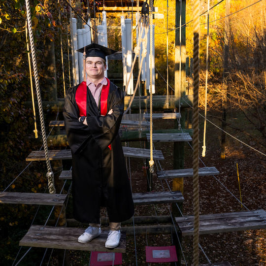 Photo of Kyle Huemme on top of the UGA ropes course