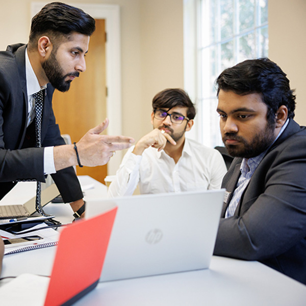 Terry MBA students working on group project on their laptops 