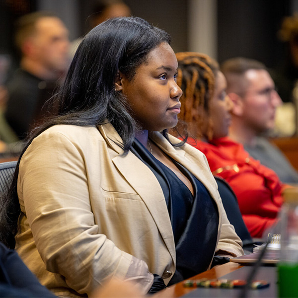 A black female PMBA student listens in class