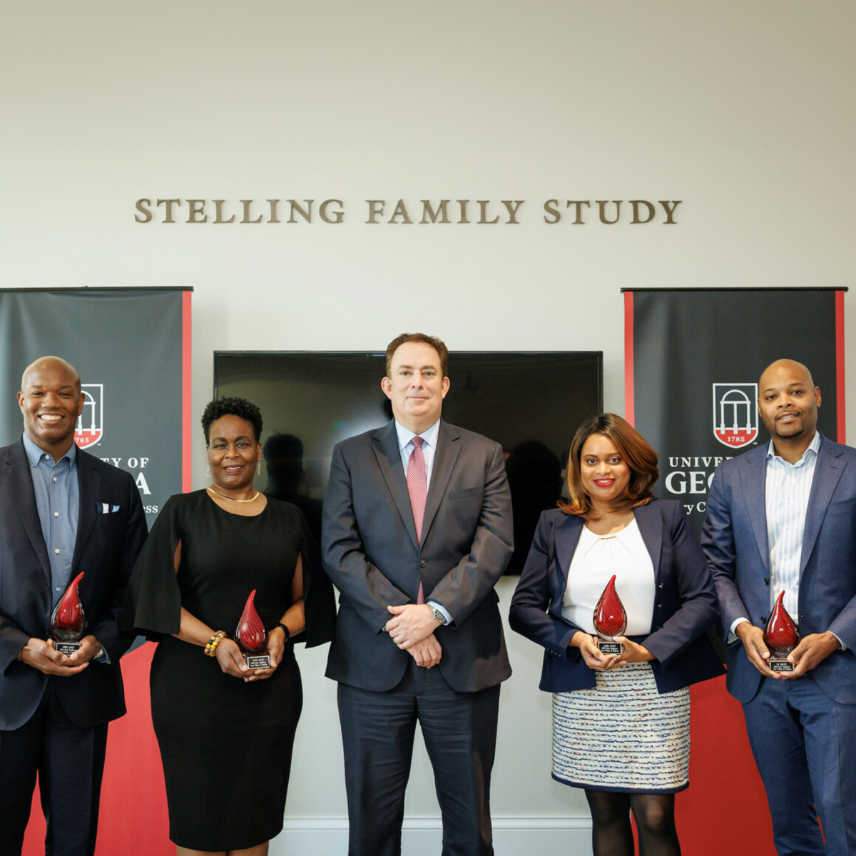 Chris Allen (BBA ’92), Tonya Davies (BBA ’95), Laura Picott (BBA ’11, AB ’11) and KB Yabuku (MBA ’10) pose with Terry Dean Ben Ayers