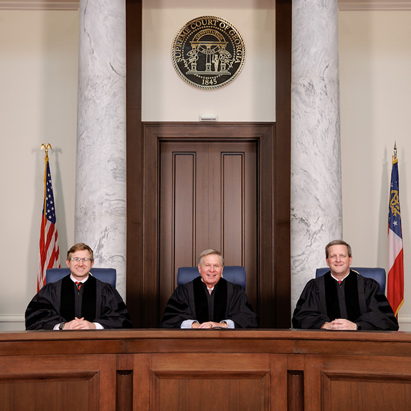 Three Georgia Supreme Court justices sit behind their bench